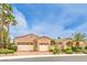 Charming home featuring manicured desert landscaping, a wrought iron gate and three car garage at 5162 Estasi St, Las Vegas, NV 89135