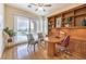 Cozy office with built-in bookshelves, desk, and view of the pool at 5162 Estasi St, Las Vegas, NV 89135