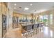 Open kitchen with a large island, stainless steel appliances, light-colored cabinets, and glass doors to the patio at 5162 Estasi St, Las Vegas, NV 89135