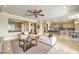 Open-concept living space with plush seating, a modern kitchen, and a seamless flow for entertaining at 5162 Estasi St, Las Vegas, NV 89135