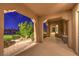 Inviting covered patio with lush landscaping and manicured garden views at twilight at 5162 Estasi St, Las Vegas, NV 89135