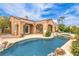 Backyard pool and spa with rock accents and lush landscaping at 5162 Estasi St, Las Vegas, NV 89135