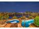 Relaxing pool and spa area with a safety fence and scenic views of the city at night at 5162 Estasi St, Las Vegas, NV 89135
