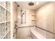Walk-in shower featuring a built-in bench, grab bars, and multiple shower heads at 5162 Estasi St, Las Vegas, NV 89135
