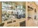 Wet bar complete with wine fridge, sink, glass shelves, and custom cabinetry, great for entertaining guests at 5162 Estasi St, Las Vegas, NV 89135