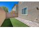 Cozy backyard featuring pavers, turf, and block wall for privacy, perfect for outdoor living at 5244 Fiery Sky Ridge St, Las Vegas, NV 89148