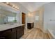 Spacious bathroom featuring a double vanity, shower, and separate tub in a naturally lit space at 5244 Fiery Sky Ridge St, Las Vegas, NV 89148