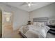 Bright bedroom with bed, chair, and doorway leading to hallway at 5244 Fiery Sky Ridge St, Las Vegas, NV 89148
