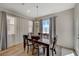 Bright dining area featuring a dark wood table, seating for six, and large windows with stylish curtains at 5244 Fiery Sky Ridge St, Las Vegas, NV 89148