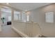 Upstairs hallway with white banister, natural light, and views into adjacent rooms at 5244 Fiery Sky Ridge St, Las Vegas, NV 89148