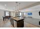 Open floor plan showcasing the kitchen island, dining area, and cozy living room, perfect for entertaining at 5244 Fiery Sky Ridge St, Las Vegas, NV 89148