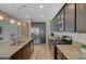 Modern kitchen featuring stainless steel appliances, dark wood cabinetry and a large island with granite countertops at 5244 Fiery Sky Ridge St, Las Vegas, NV 89148