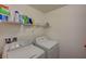 Functional laundry room with appliances and shelving for storage and organization at 5244 Fiery Sky Ridge St, Las Vegas, NV 89148