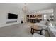 Spacious living room features an open layout with modern decor, fireplace, and an adjacent kitchen and dining area at 5244 Fiery Sky Ridge St, Las Vegas, NV 89148