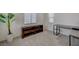 Well-lit living room with neutral carpet, display cabinet and study desk at 5244 Fiery Sky Ridge St, Las Vegas, NV 89148