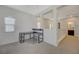 Bright loft area featuring a built-in desk, window with blinds, and hallway with bathroom view at 5244 Fiery Sky Ridge St, Las Vegas, NV 89148