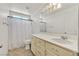 Bright bathroom featuring a white vanity, modern fixtures, and a shower/tub combo at 5250 Chester Creek Ct, Las Vegas, NV 89141