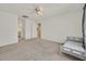 Neutral bedroom with a ceiling fan, ensuite bathroom and doorway to the hallway at 5250 Chester Creek Ct, Las Vegas, NV 89141