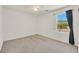Bright bedroom featuring a large window and neutral carpet at 5250 Chester Creek Ct, Las Vegas, NV 89141