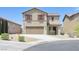 Two-story home with a beige stucco finish, red shutters, and a two-car garage in a suburban neighborhood at 5250 Chester Creek Ct, Las Vegas, NV 89141