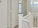 Hallway with white bannister, doorway to a bathroom and a linen closet at 5250 Chester Creek Ct, Las Vegas, NV 89141