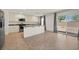 Well-lit kitchen featuring stainless steel appliances, a granite countertop island, and a sliding glass door to the yard at 5250 Chester Creek Ct, Las Vegas, NV 89141