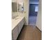 Bathroom with a long vanity and tile flooring, leading into the next room at 5389 Spencer St, Las Vegas, NV 89119