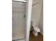 Bathroom featuring a standing shower with white tiles, toilet, and tiled flooring at 5389 Spencer St, Las Vegas, NV 89119