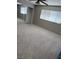 Bright bedroom with neutral carpet, paint, and a ceiling fan for added comfort at 5389 Spencer St, Las Vegas, NV 89119