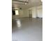 Spacious garage featuring painted flooring and ample room for parking and storage at 5389 Spencer St, Las Vegas, NV 89119