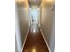 Long hallway with hardwood floors and neutral wall paint at 5389 Spencer St, Las Vegas, NV 89119