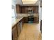 Kitchen featuring wooden cabinets, stainless steel appliances, and tile flooring at 5389 Spencer St, Las Vegas, NV 89119