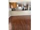 Open kitchen featuring wooden cabinets, a tiled backsplash, and wood laminate flooring at 5389 Spencer St, Las Vegas, NV 89119