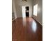 Open living room with beautiful wood laminate flooring and natural light streaming through the window at 5389 Spencer St, Las Vegas, NV 89119