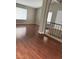 Bright living room showcasing wood laminate floors, neutral paint, and a staircase with iron railings at 5389 Spencer St, Las Vegas, NV 89119