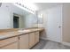 Bathroom featuring long countertop with cabinets, single sink, large mirror and vinyl floors at 555 E Silverado Ranch Blvd # 2164, Las Vegas, NV 89183