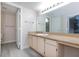 Bathroom with a long vanity with cabinets, bright lighting and vinyl floors at 555 E Silverado Ranch Blvd # 2164, Las Vegas, NV 89183