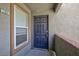 This view shows the entrance to the unit, featuring a front door with a window to the left at 555 E Silverado Ranch Blvd # 2164, Las Vegas, NV 89183