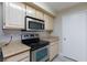 Close-up of stainless steel kitchen appliances and bright, light cabinets at 555 E Silverado Ranch Blvd # 2164, Las Vegas, NV 89183