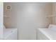 Bright laundry room with white appliances and wire shelving for ample storage at 555 E Silverado Ranch Blvd # 2164, Las Vegas, NV 89183