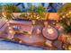 Aerial view of the backyard featuring a fire pit, outdoor kitchen, and ample seating at 5779 Baffy Cir, Las Vegas, NV 89142