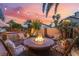 Cozy fire pit with seating, outdoor kitchen, and palm trees creates a relaxing outdoor retreat at 5779 Baffy Cir, Las Vegas, NV 89142