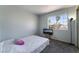Simple bedroom featuring a full-sized bed, window, and a minimalistic design at 5779 Baffy Cir, Las Vegas, NV 89142