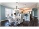 Chic dining room with modern chandelier and easy access to the well-equipped kitchen at 5779 Baffy Cir, Las Vegas, NV 89142
