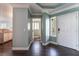 Inviting entryway with dark wood floors, white trim, and a view into the kitchen at 5779 Baffy Cir, Las Vegas, NV 89142