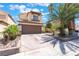 Charming two-story home with a well-maintained lawn, a two-car garage, and mature palm trees at 5779 Baffy Cir, Las Vegas, NV 89142