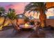 Cozy fire pit area is perfect for outdoor entertaining, featuring comfortable chairs and ambient lighting at 5779 Baffy Cir, Las Vegas, NV 89142