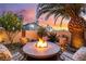 Cozy fire pit area is perfect for outdoor entertaining, featuring comfortable chairs and ambient lighting at 5779 Baffy Cir, Las Vegas, NV 89142