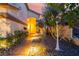 Inviting front entrance with lush landscaping, rock features and a well-lit walkway at 5779 Baffy Cir, Las Vegas, NV 89142