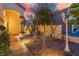 Inviting front entrance with lush landscaping, rock features and a well-lit walkway at 5779 Baffy Cir, Las Vegas, NV 89142